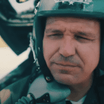 Gov. Ron DeSantis, shown posing as a fighter pilot in a campaign ad, wants his real-life jet travel shielded from public view.