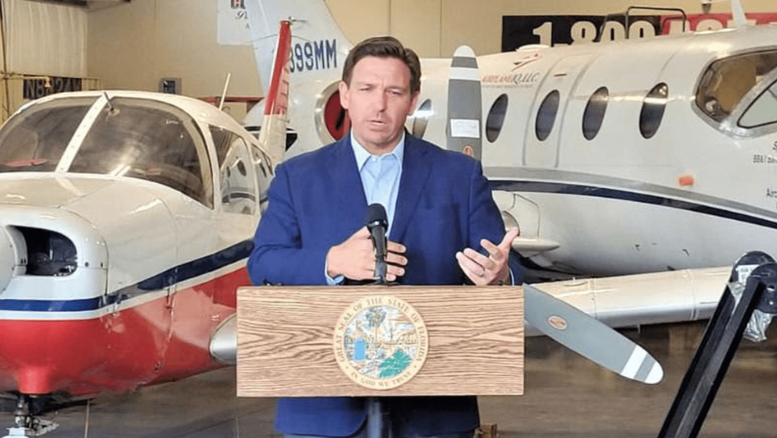 DeSantis standing in front of planes.